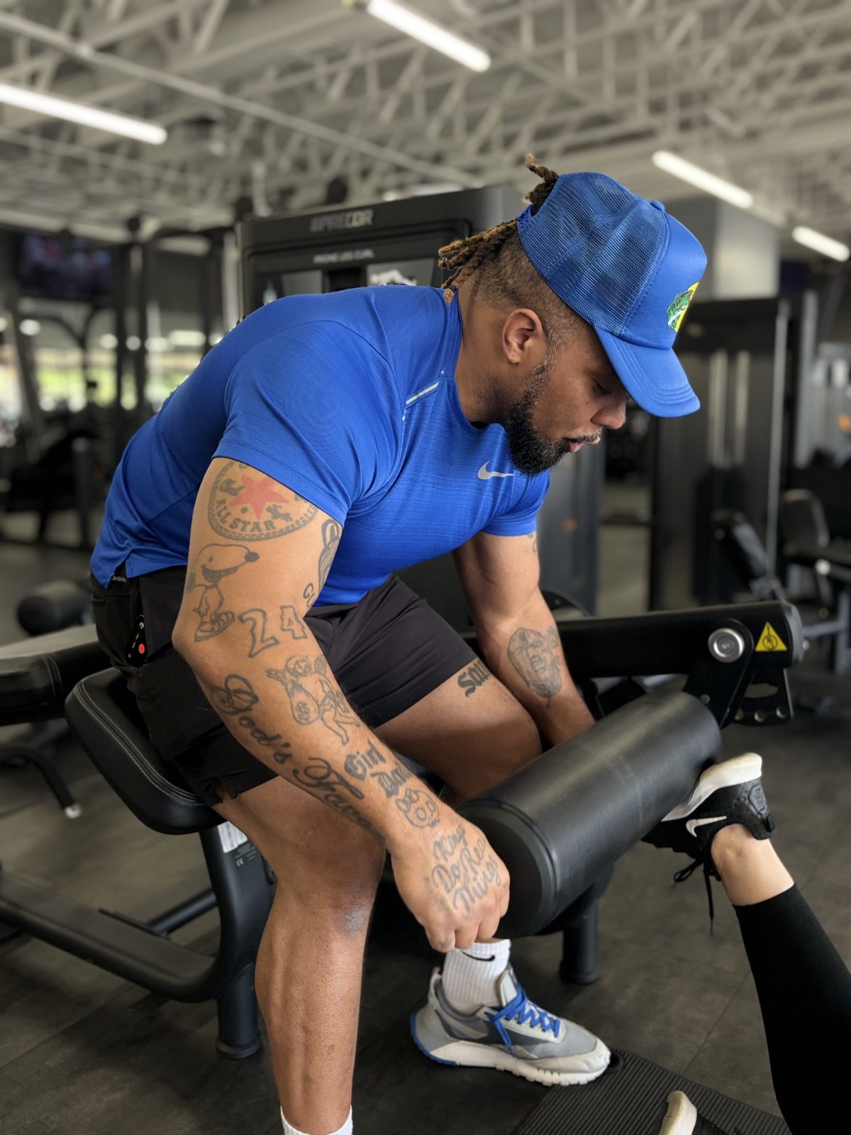 Justin coaching form on a leg curl machine — Anytime Fitness Ahwatukee North
