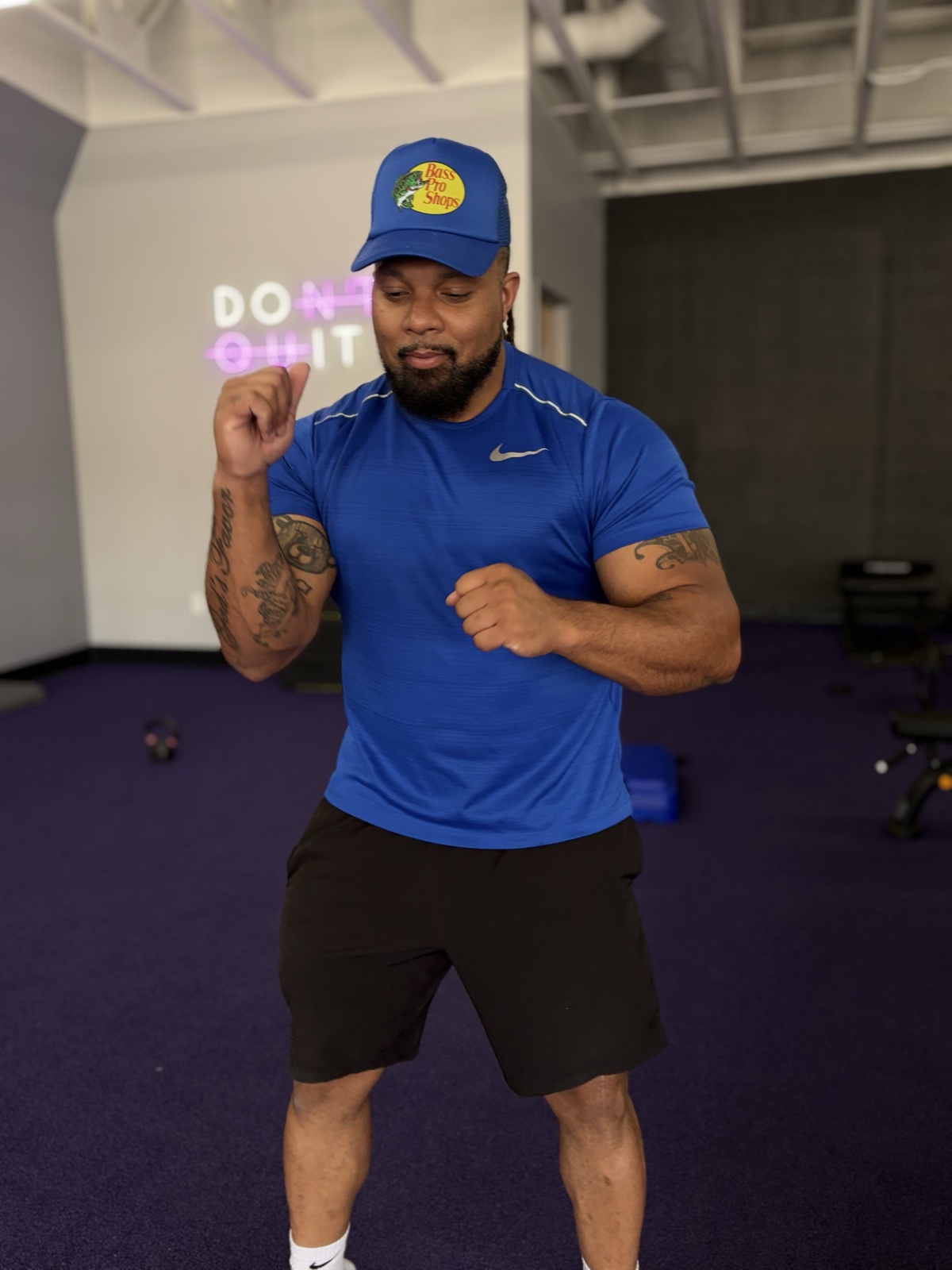 Justin in the functional zone — DON'T QUIT neon visible behind