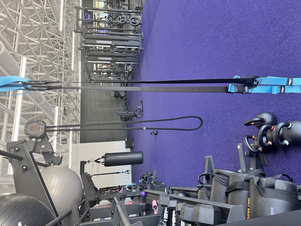 TRX suspension trainers and kettlebells under the vaulted ceiling